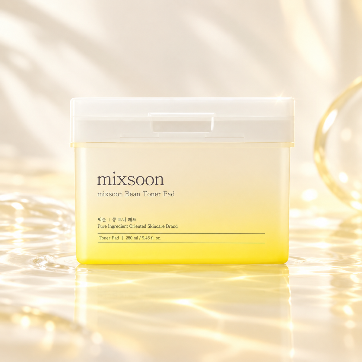 Mixsoon Bean Toner Pad 280ml Korean skincare toner pads in a minimalist yellow container with a white lid, presented on a glossy reflective surface. Surrounded by warm golden light, delicate water ripples and soft beige tones, highlighting a luxurious K-beauty skincare aesthetic and a fresh, hydrated complexion.