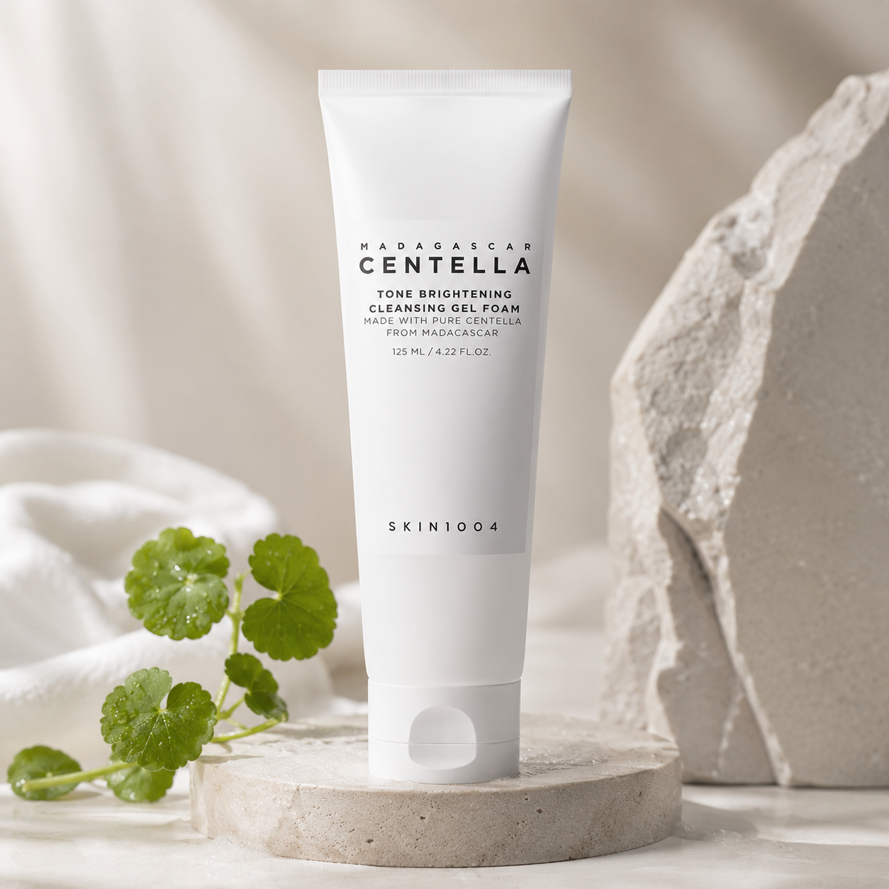 SKIN1004 Madagascar Centella Tone Brightening Cleansing Gel Foam 125ml with a green plant on a neutral background
