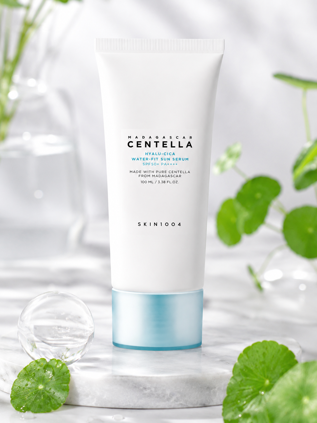 SKIN1004 Madagascar Centella Hyalu-Cica Water-Fit Sun Serum 100ml with green leaves on a light background